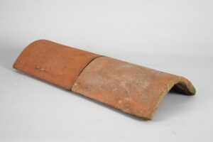 Traditional Red Clay Hogsback Ridge Tile, known for its unique curvature and vibrant colour, adding timeless elegance and durability to roofs.