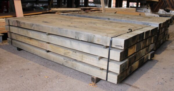 Newly cut hardwood railway sleepers, showcasing the rich texture and robust quality, perfect for innovative garden and landscaping designs.