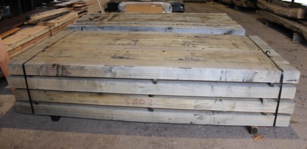 Newly cut hardwood railway sleepers, showcasing the rich texture and robust quality, perfect for innovative garden and landscaping designs.