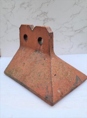Reclaimed Apex Angled Fancy Stop End Ridge Tile in Clay Red with Two Hole Crested design, embodying traditional elegance