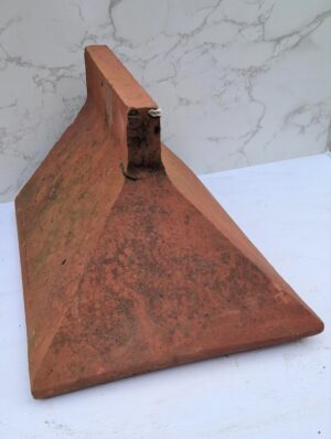 Elegant Reclaimed Apex Angled Stop End Ridge Tile in Red Clay with a subtle Plain Crested design, adding a classic touch to rooftops