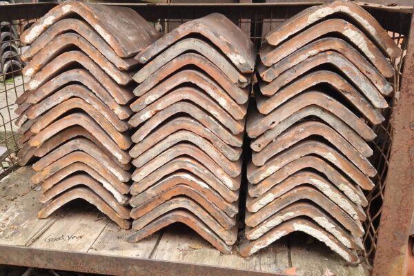 Reclaimed Terracotta Saddle Back Ridge Tile at 105 degrees, showcasing the natural beauty and architectural integrity of historical craftsmanship.