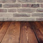 wooden flooring with brick wall