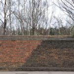 Brick,Wall,With,Two,Different,Colours,Of,Brickwork,And,Trees